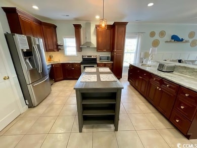 Kitchen featuring a center island, wall chimney ex
