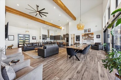 Living room with a high ceiling, beam ceiling, li