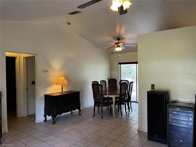 Dining space featuring lofted ceiling and light ti