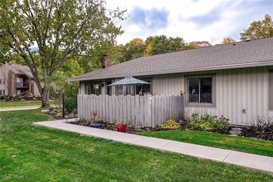 View of front of home featuring a chimney, a shingled roof, and board and batten siding