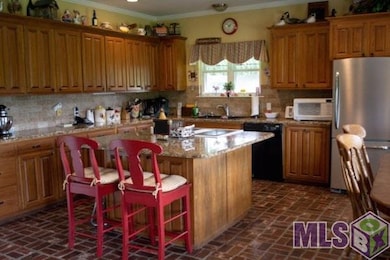 Cypress cabinets, granite counters, brick paver fl