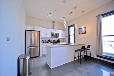 Kitchen with stainless steel appliances, updated white cabinetry