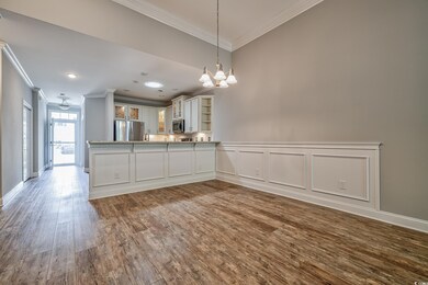 Kitchen with stainless steel appliances, crown molding, dark wood-style flooring, a chandelier, and open shelves