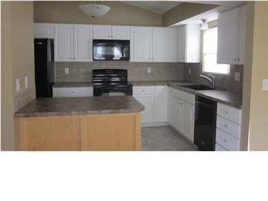 Charming neutral kitchen features separate pantry,