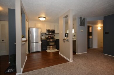 Kitchen with laminate wood flooring and Stainless 