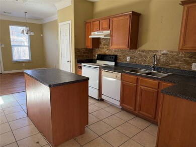 Spacious kitchen with granite look countertops.