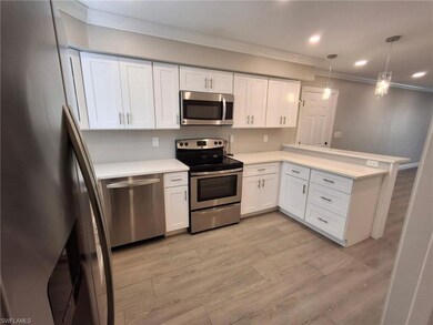 Kitchen featuring hanging light fixtures, stainles