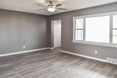 Spacious, sun-filled living room with a picture wi