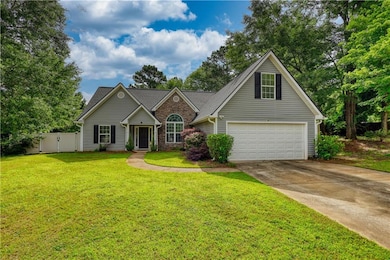 Traditional home featuring concrete driveway, an attached garage, and a gate