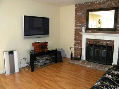 Family room w/ brick fireplace and wood laminate f