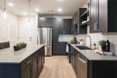 Kitchen with decorative backsplash, stainless stee