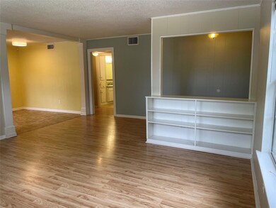 Spare room featuring baseboards, a textured ceili