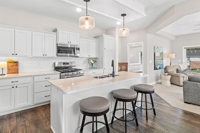 Stunning gourmet kitchen with bright lighting and cool light fixtures.