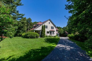 Driveway leads past the house to the...