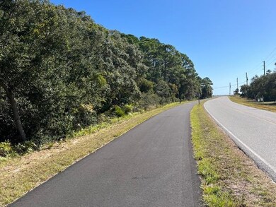 Newly constructed bike path runs in front of lot.