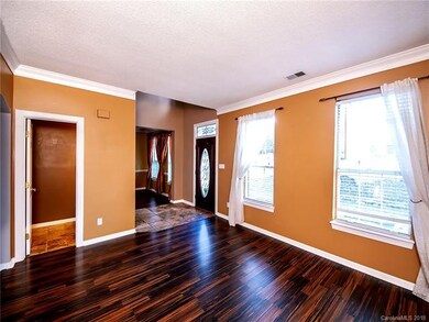 Living room with view to foyer featuring tons of n