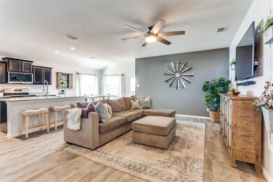 Living area with baseboards, light wood-style floo