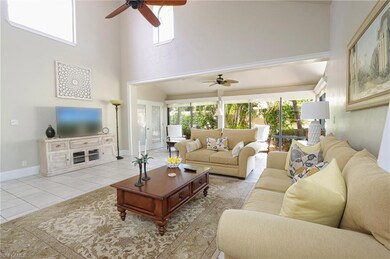 Tiled living room featuring a healthy amount of sunlight and ceiling fan