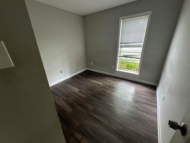 Unfurnished room featuring dark hardwood / wood-st