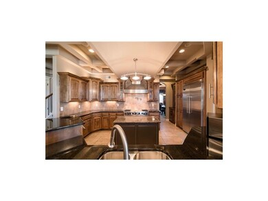 Chef's kitchen offers granite counters, commercial