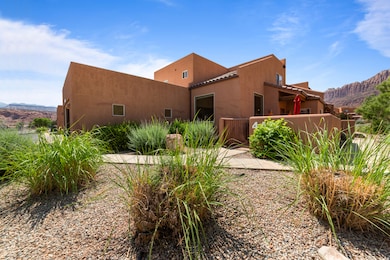 View of front of home featuring a mountain view, stucco siding, and a tiled roof