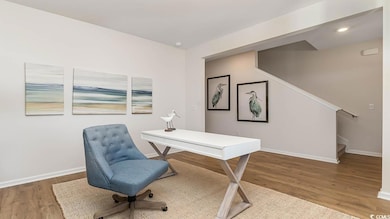 Office space featuring wood finished floors, baseboards, and recessed lighting