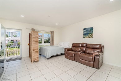 Bedroom with recessed lighting, light tile patterned floors, and access to outside