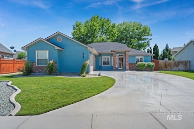 Ranch-style house featuring brick siding, driveway, and a garage