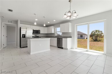 Kitchen featuring a chandelier, stainless steel ap
