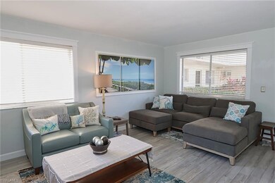 Living room with light hardwood / wood-style floor