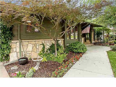 Perennials & annual flowers line the sidewalk.
