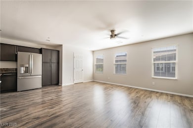 Unfurnished living room featuring a ceiling fan, p