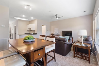 Dining area featuring light carpet, ceiling fan, a