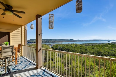 Balcony with a ceiling fan, a water view, and a s