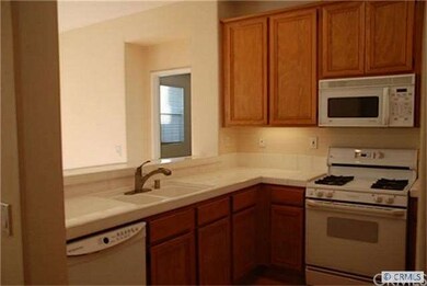 Other view of kitchen. Newer dishwasher and other 