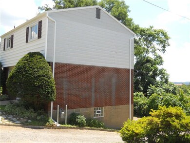 side view driveway and glass block window.