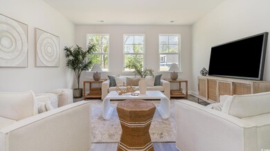 Living area with wood finished floors and healthy amount of natural light