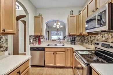 Kitchen featuring backsplash, a notable chandelier