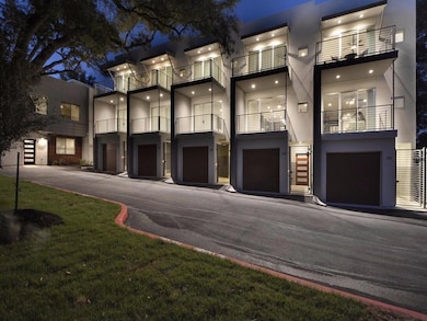 View of front of home with a garage and stucco si