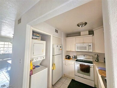Kitchen featuring stacked washer and clothes dryer