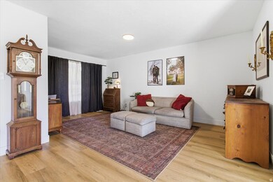 Living area with light wood-type flooring and baseboards