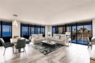 Living room featuring a water view, expansive wind