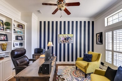 Office space with ornamental molding and ceiling f
