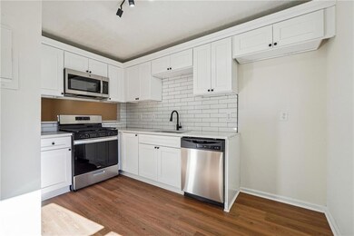 Kitchen with stainless steel appliances, a sink, d