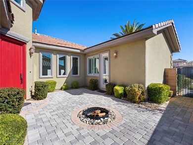 View of patio with a gate and a fire pit