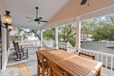 Wooden deck with a ceiling fan and outdoor dining area
