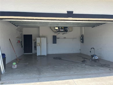 Garage featuring white fridge with ice dispenser a