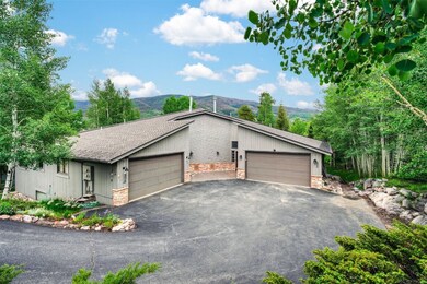 View of front of house with a shingled roof, stone