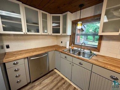 Kitchen featuring dishwasher, tasteful backsplash,