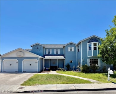 Traditional-style home featuring concrete driveway, a front lawn, and a garage